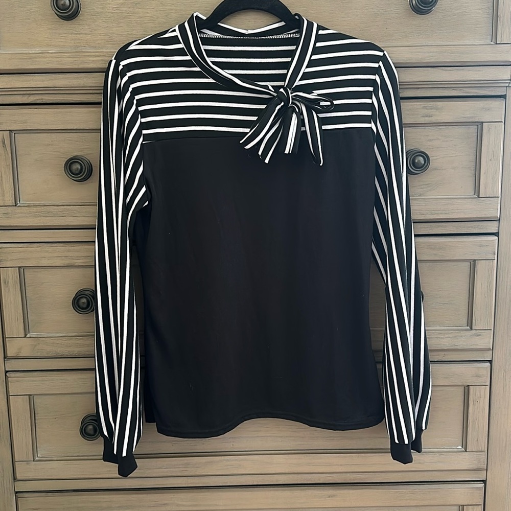 Black and white, striped and solid, long sleeve women’s top.